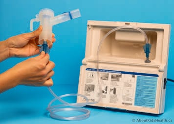 The tubing from the compressor is attached to the bottom of the nebulizer