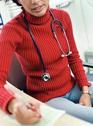 Healthcare professional taking notes