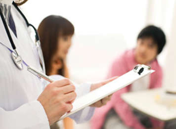 Doctor taking with clipboard